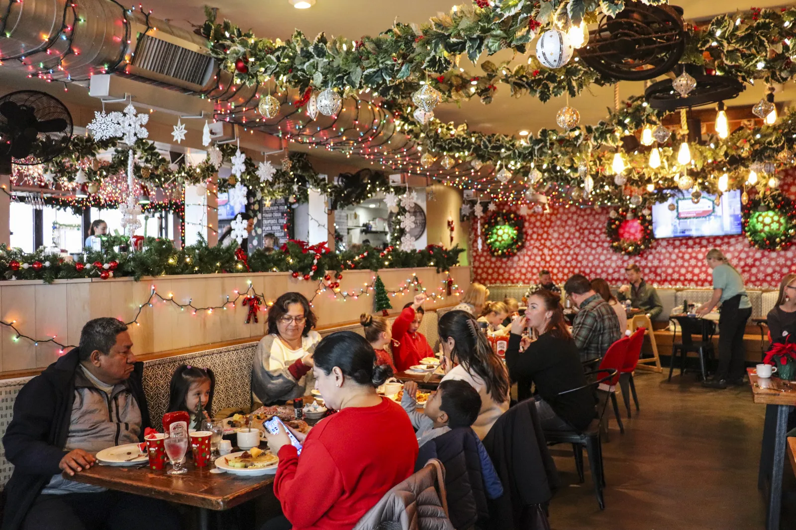 Holiday marketing ideas for restaurants and bars: guests at a festive holiday brunch at Harry's Jingle Bar in Cape May